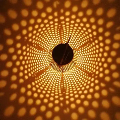Lanterne solaire DOTY Lumisky posée sur table en bois, ambiance chaleureuse soirée extérieure, métal cuivré perforé, lumière blanc chaud diffuse