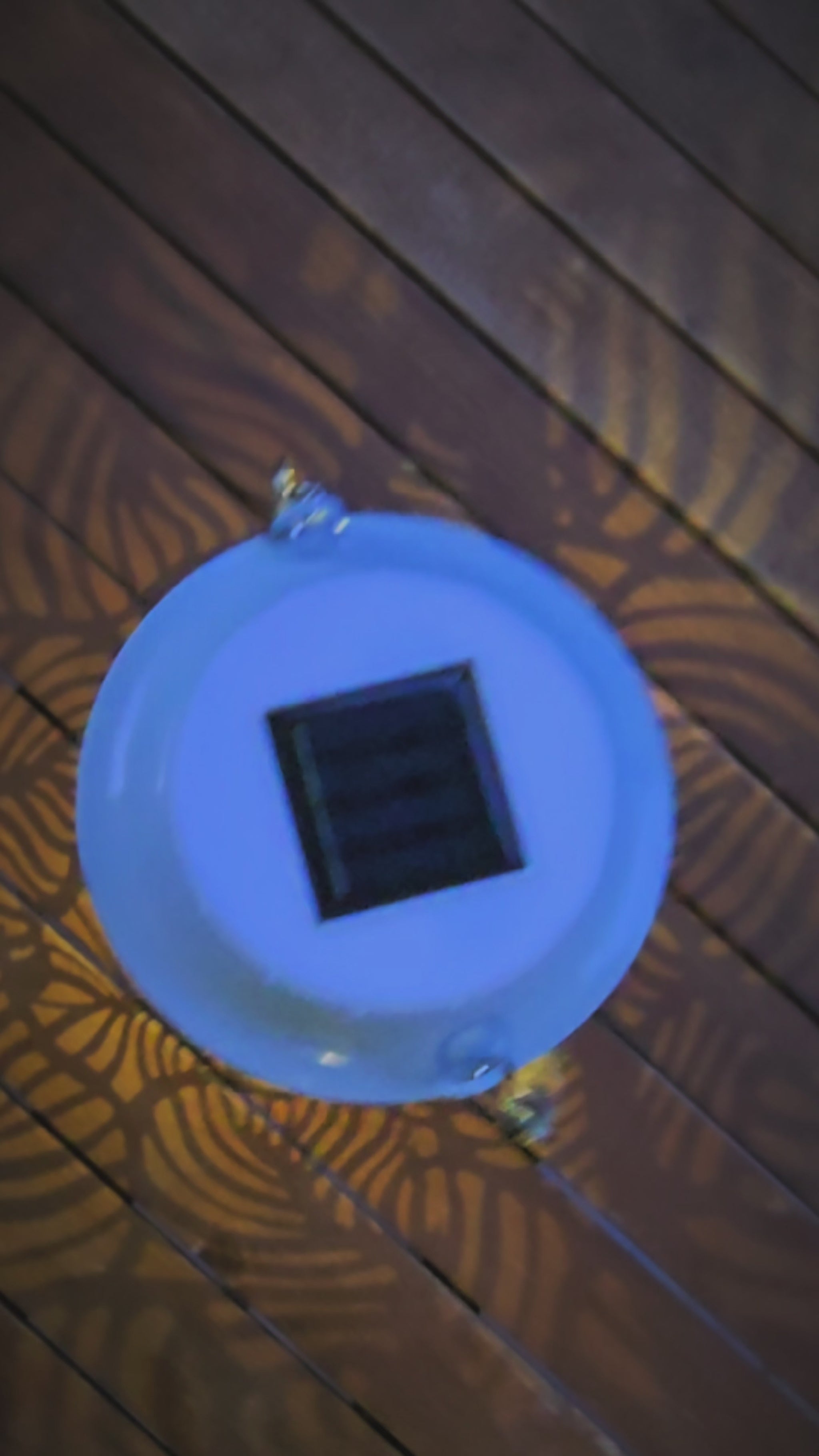 Vidéo — Lanterne solaire bohème Mini Rainbow Lumisky en métal blanc ajouré : vues alternées jour et nuit, motifs de feuilles projetant de jolis jeux d'ombres et une lumière LED blanc chaud — LLX ConceptStore
